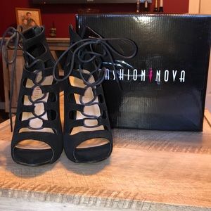 Black lace up heel booties.